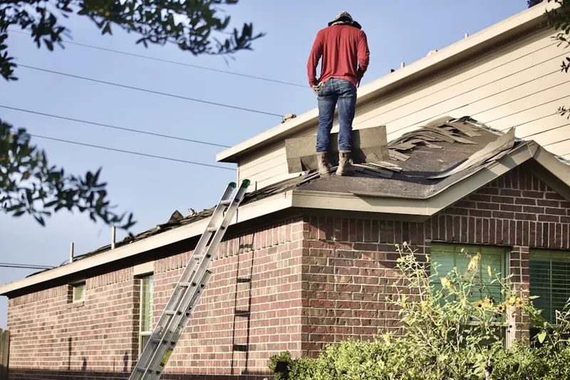 Professional roofer working on a residential roof in Powder Springs